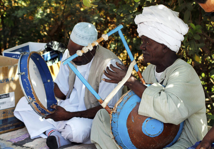 Nubian culture today. Men playing music on traditional instruments.