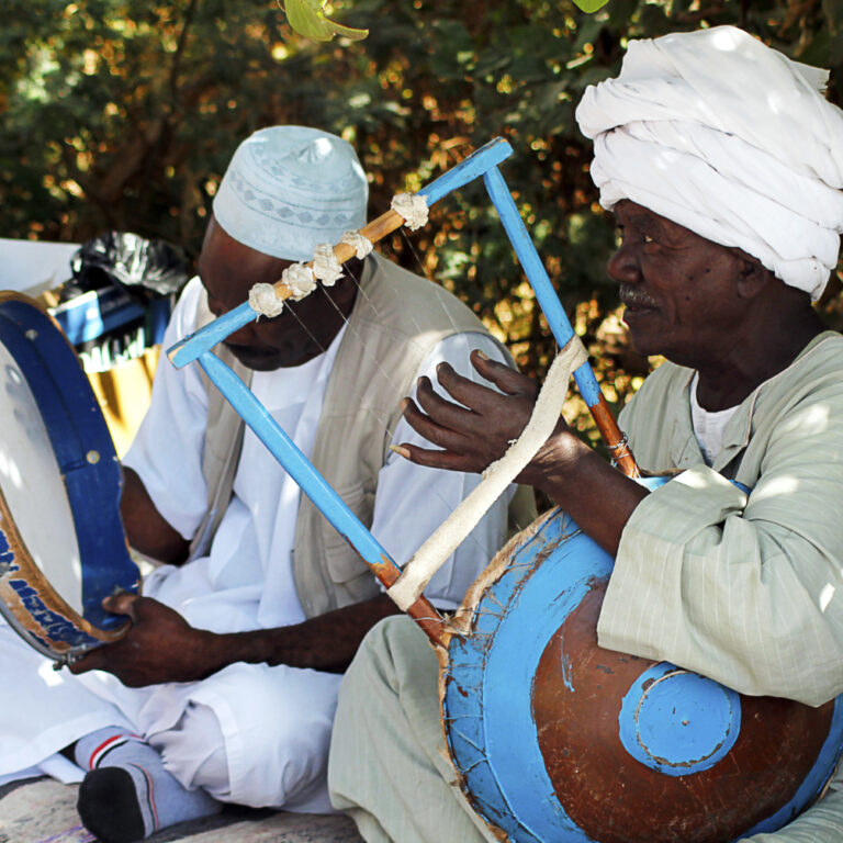 The Living Legacy of Nubia: Egypt’s Ancient Southern Kingdom Nubian culture today. Men playing music on traditional instruments.